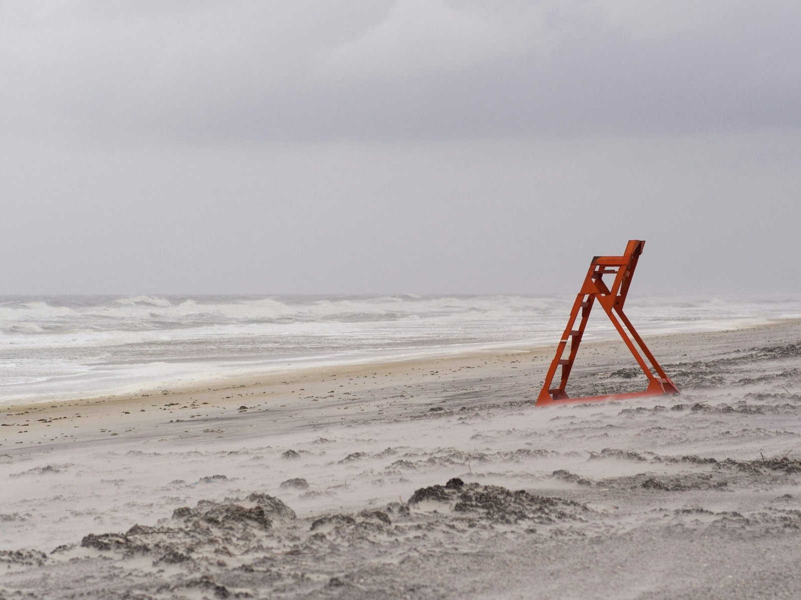 Beaches in Goa red metal ladder stand near seashore during daytime